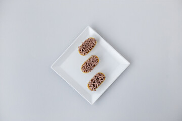 Tartlet with chocolate mousse on a white plate for catering, space for design