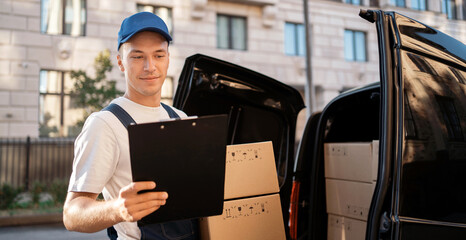 The employee carries the order home to the client. Express service a man in a uniform delivers...