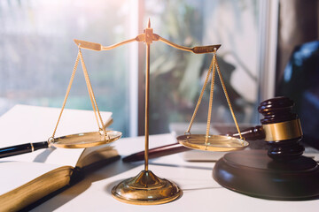 Business and lawyers discussing contract papers with brass scale on desk in office. Law, legal...