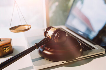 Business and lawyers discussing contract papers with brass scale on desk in office. Law, legal services, advice, justice and law concept picture with film grain effect