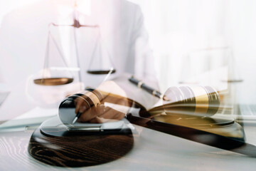 Business and lawyers discussing contract papers with brass scale on desk in office. Law, legal services, advice, justice and law concept picture with film grain effect