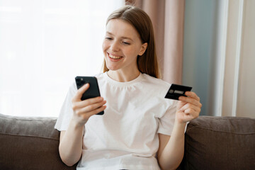 Online purchases are paid in the app. Student shopping at home. A woman is sitting and writing a message to a client by mail.