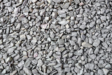 Crushed rock close up. Small rocks ground. Crushed stone road building material gravel texture. Small stone construction material rock. Garden gravel background stone landscaping. Driveway gravel road