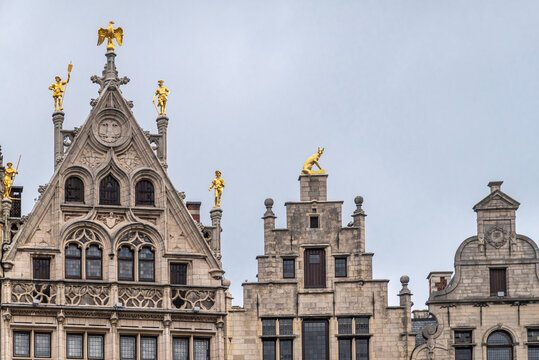 Antwerpen, Belgium - August 1, 2021: Grote Markt historic medieval houses. Row of 3 gables, the eagle and the rainbow with smaller one on right under blue sky. Golden statues.