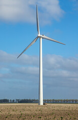 Fototapeta na wymiar Windmill in grass field