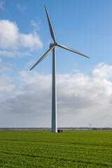 Windmill in grass field