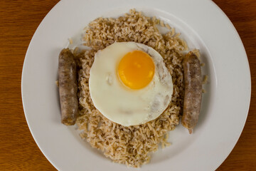 brown rice top with fried egg and sausage