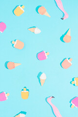 Colorful, vibrant, summer party refreshment texture isolated on pastel blue background. Sun and shadows. Ice cream refreshment note card concept. Minimal flat lay. Leisure vacation pattern idea.