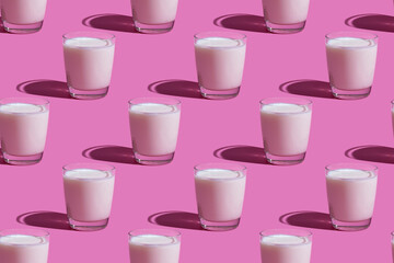World Milk Day. Pattern on a pink background. A glass of milk. Pattern.