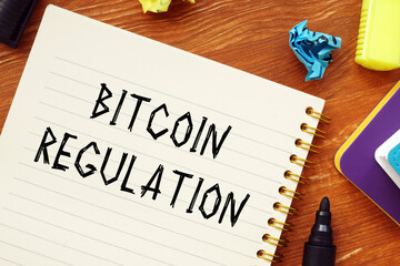 Business concept about BITCOIN REGULATION question marks with phrase on the piece of paper.