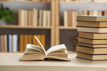Many books on wooden table in library