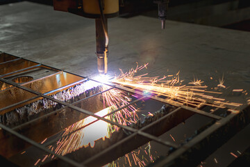 CNC plama machine cutting metal throwing sparks