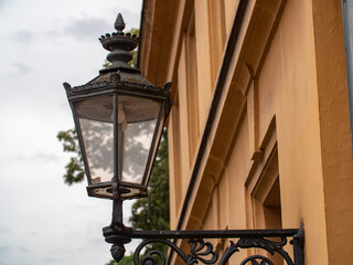 Fototapeta na wymiar Ancient electric street lamp on house.