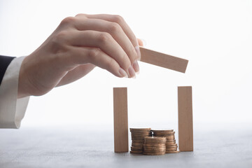 hand protects coins on white background, safe concept, financial risk insurance, reliable bank, financial advisor