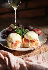 Eggs Benedict with smoked salmon, Hollandise sauce on bread