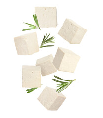 Cubes of raw tofu falling on white background