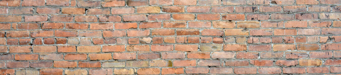 Brick wall as a rough textured and patterned abstract background
