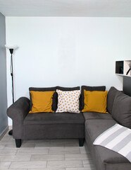 Living room with gray tones and a touch of mustard