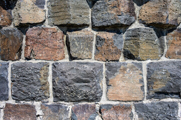 Hand carved blocks in a rustic wall, as an abstract background
