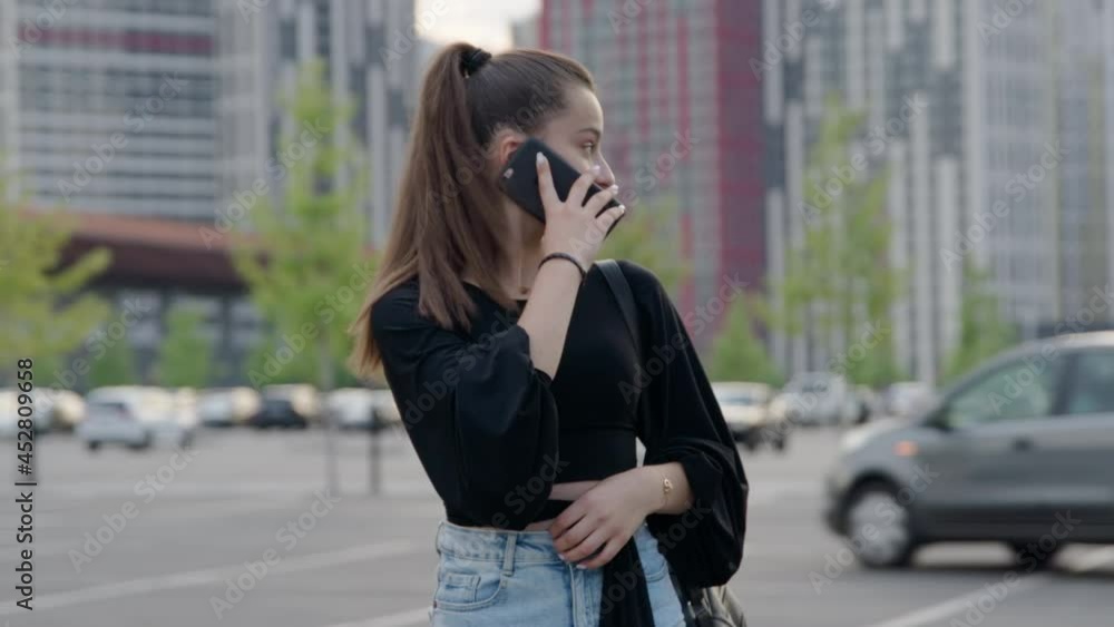 Wall mural beautiful female teenager talking on the phone outdoors