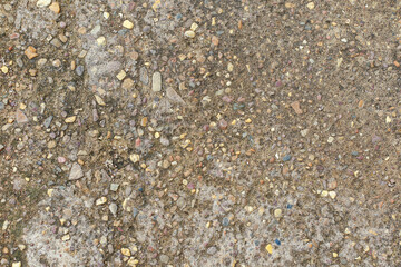 Abstract background. Concrete cement floor with little rock inside.