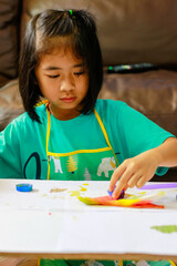 Young girl doing art work at home. Online learning in a new normal concept.