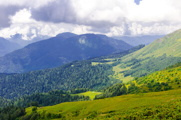 Obraz premium Beautiful Summer sunny mountains with clouds and meadow