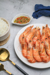 Fresh boiled big sea shrimps (prawns) with spicy seafood sauce and rice. Healthy food. Cooked steamer food served seafood.