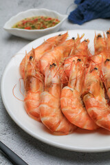 Fresh boiled big sea shrimps (prawns) with spicy seafood sauce and rice. Healthy food. Cooked steamer food served seafood.