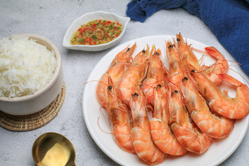 Fresh boiled big sea shrimps (prawns) with spicy seafood sauce and rice. Healthy food. Cooked steamer food served seafood.