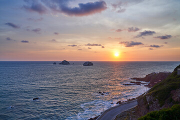 Fototapeta premium Mazatlán Mexico Beach Sunset with Costal Road and View of Rock Formations and Cliff. 