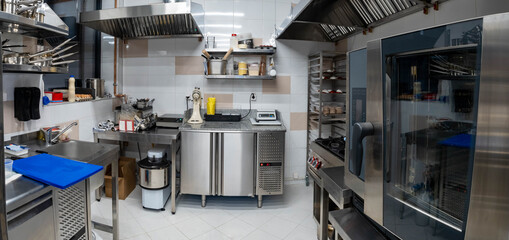 Restaurant kitchen. confectionery shop of restaurant without people. Kitchen with professional restaurant equipment. Concept - sale of equipment for changing HoReCa. Combi ovens in cafe kitchen