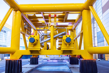 Gas processing plant. Yellow plant for methane processing. Street gas processing unit. Yellow pipes...