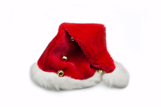 Santa Clauses red hat with golden bells isolated on white background.