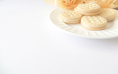 close up vanilla creme cookies and flower flat lay  