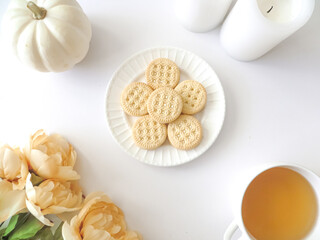 mini pumpkin cookies and tea flat lay scene 