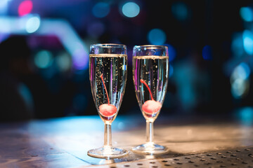 Iced cocktail in a glass at a nightclub. Colorful footage in a nightclub. Alcoholic drink of different colors. Nightlife scene. Shots at the bar table