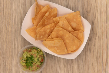 Overhead view of hearty side order of chips and guacamole served as an appetizer