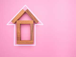 Obraz na płótnie Canvas Home loan and real estate investment concept. Small wooden house with line effect isolated on pink background. Home insurance. Top view