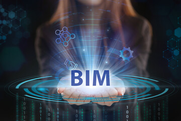 Business, Technology, Internet and network concept. Young businessman working on a virtual screen of the future and sees the inscription: BIM