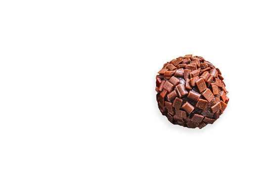 Brigadeiro, a traditional Brazilian sweet made with chocolate with sprinkles, on white background with space for text.