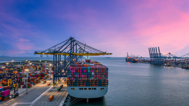 Container ship in seaport at night, Global business logistic import export freight shipping transportation oversea worldwide container ship, Container vessel loading cargo freight ship.