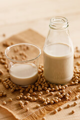 Obraz na płótnie Canvas soy milk in a bottle on wooden table