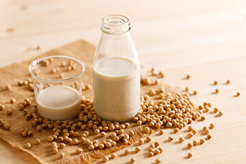 soy milk in a bottle on wooden table