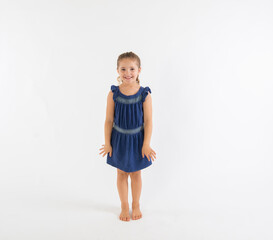 Excited happy preschool girl in blue dress isolated on white background