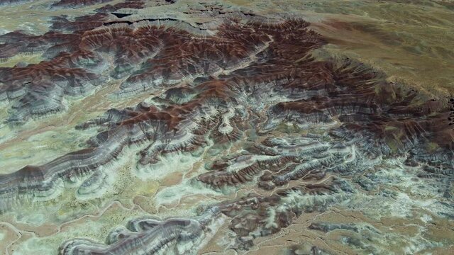 Cinematic aerial shot of colorful strata of Painted Desert in Arizona