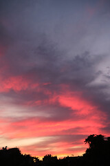 Colorful clouds and city silhouette at sunset