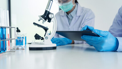 Team of Medical Research Scientists or researcher in lab coat testing their experimental in Modern laboratory.