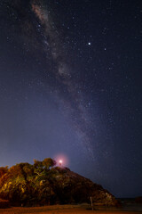 Person holding a torch with Milkyway in the sky on top of Miami hill, Gold Coast