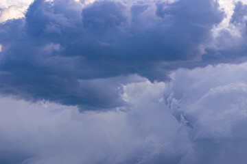 Naklejka na ściany i meble Deep dark blue grey menacing stormy clouds